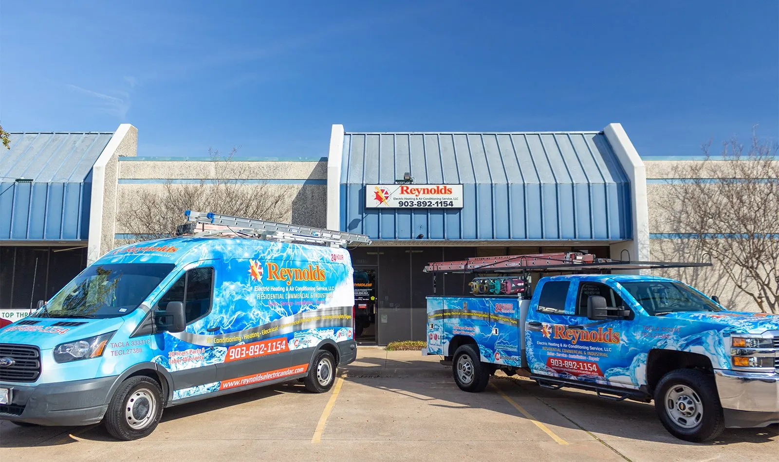 Two Ray's Pools service vehicles parked in front of a business with the company logo.
