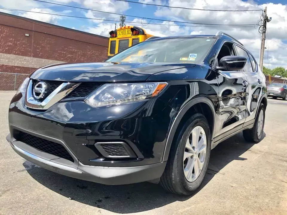 Black Nissan SUV parked outdoors on a sunny lot, front-left view.