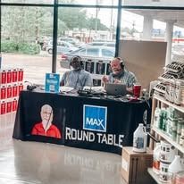Two men at a table with microphones, a