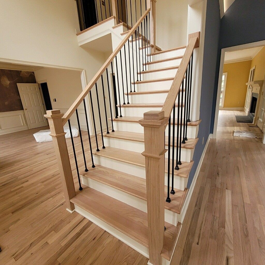 Wooden staircase with black metal balusters in a home