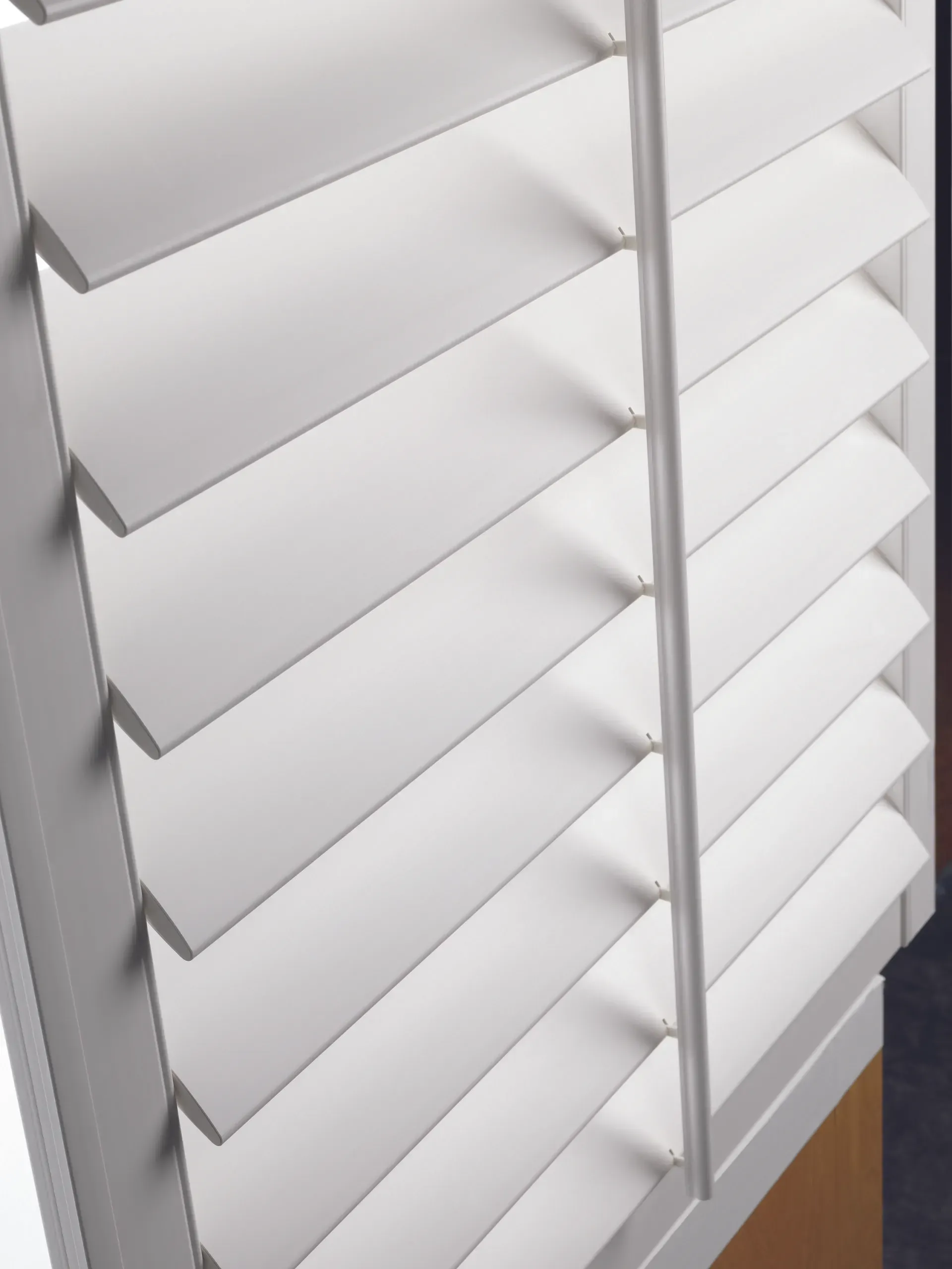 A close up of a white shutter on a window