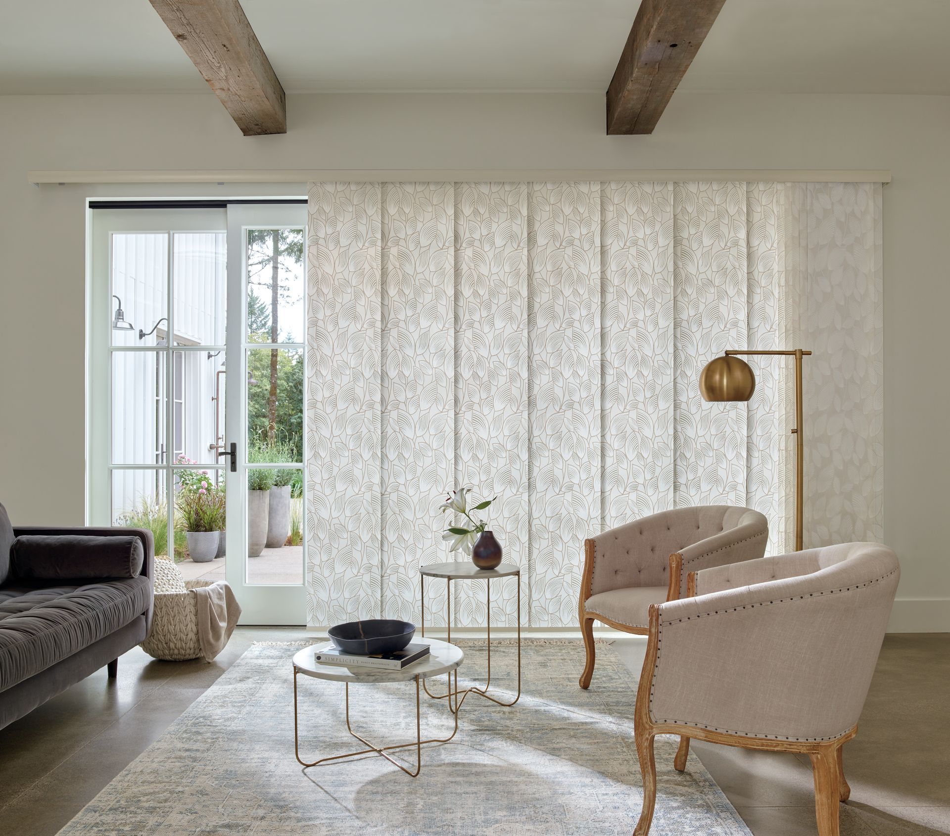 A living room with a couch , chairs , and a table.