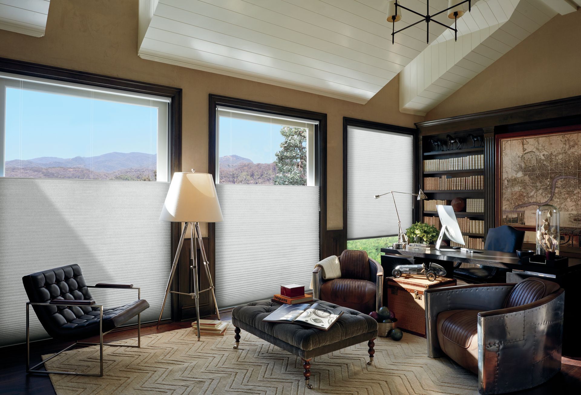 A living room with a desk chairs and a coffee table
