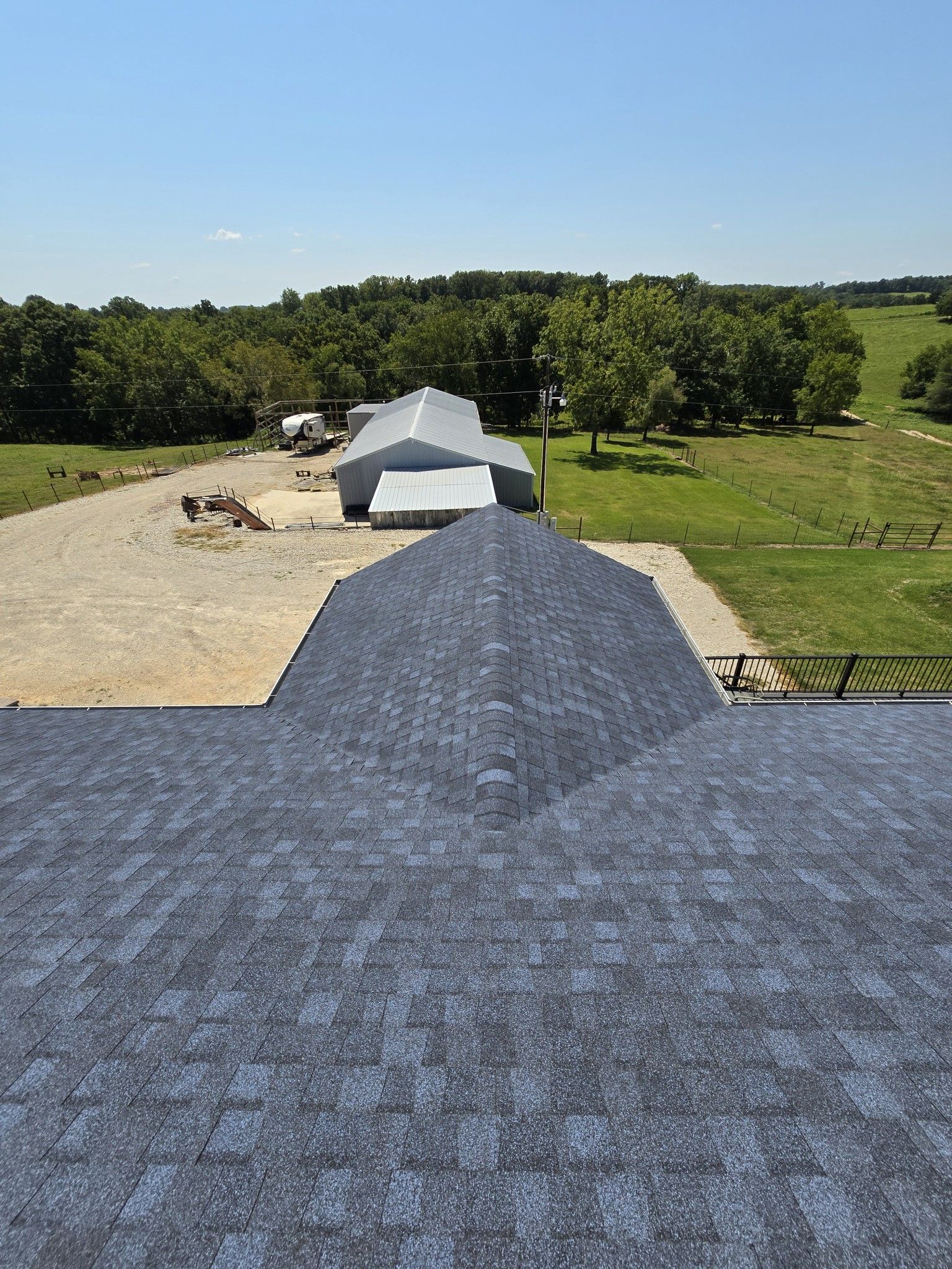 A view of a farm from the roof of a building.
