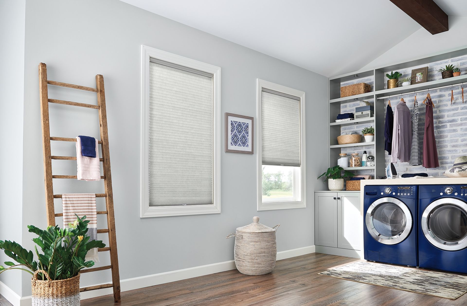 A laundry room with a ladder and a washer and dryer.