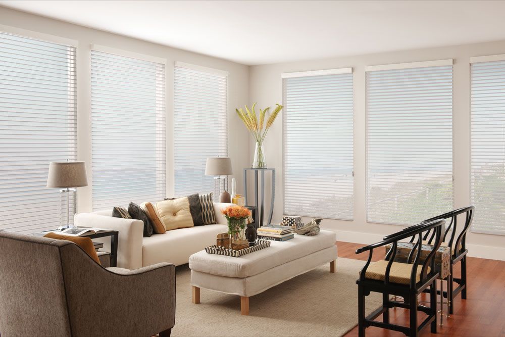 A living room with a couch , chairs , and a table.