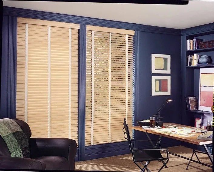 A living room with blue walls and wooden blinds