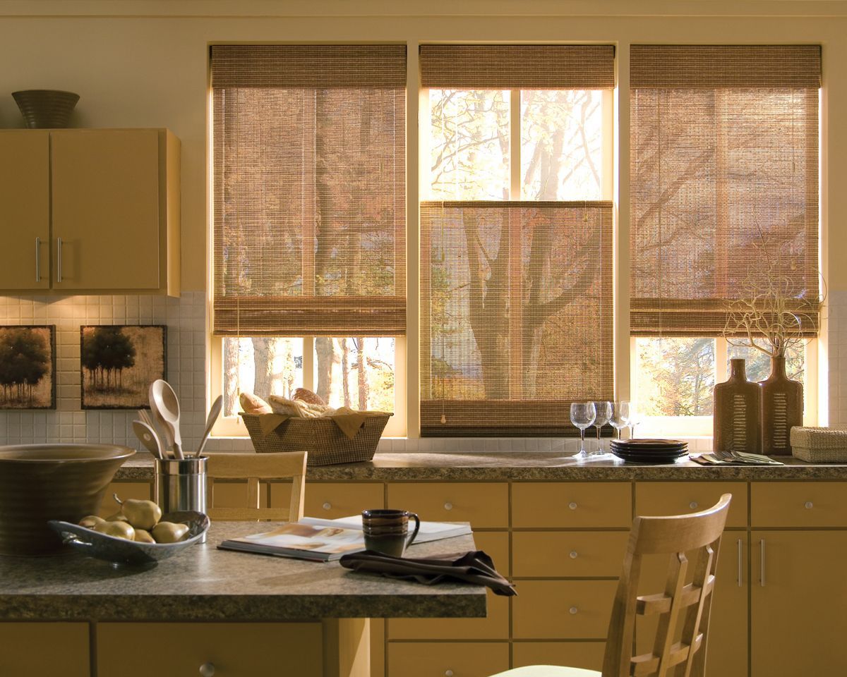 A kitchen with a table and chairs and a bowl of food on the counter.