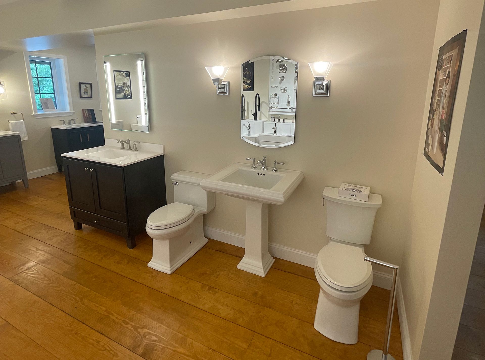 A bathroom with two toilets , a sink , and a mirror.