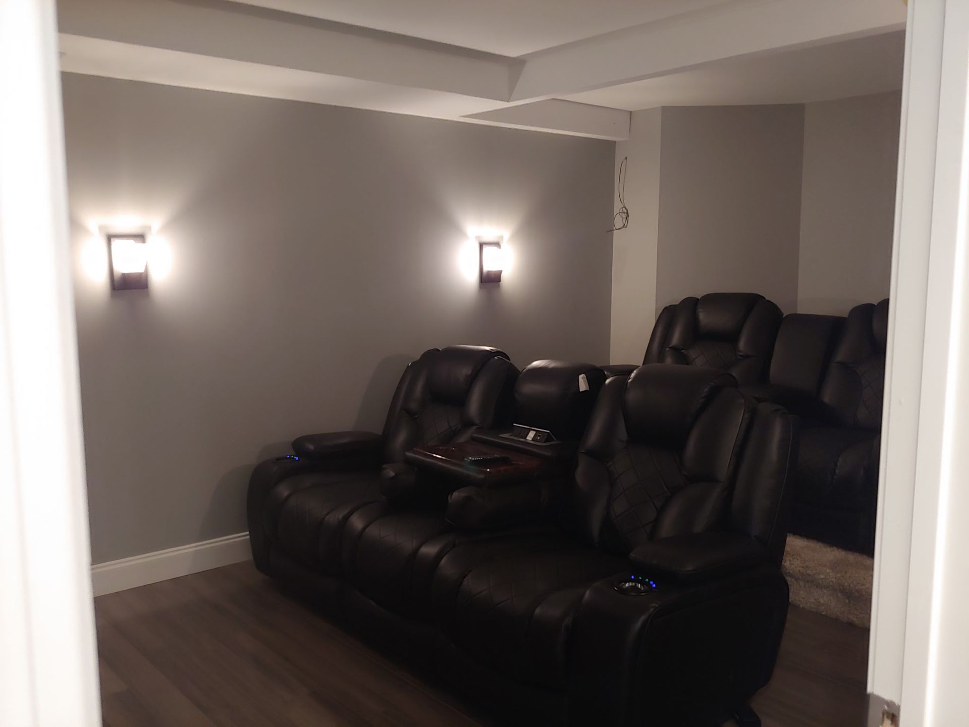 A room with a couch and chairs in it