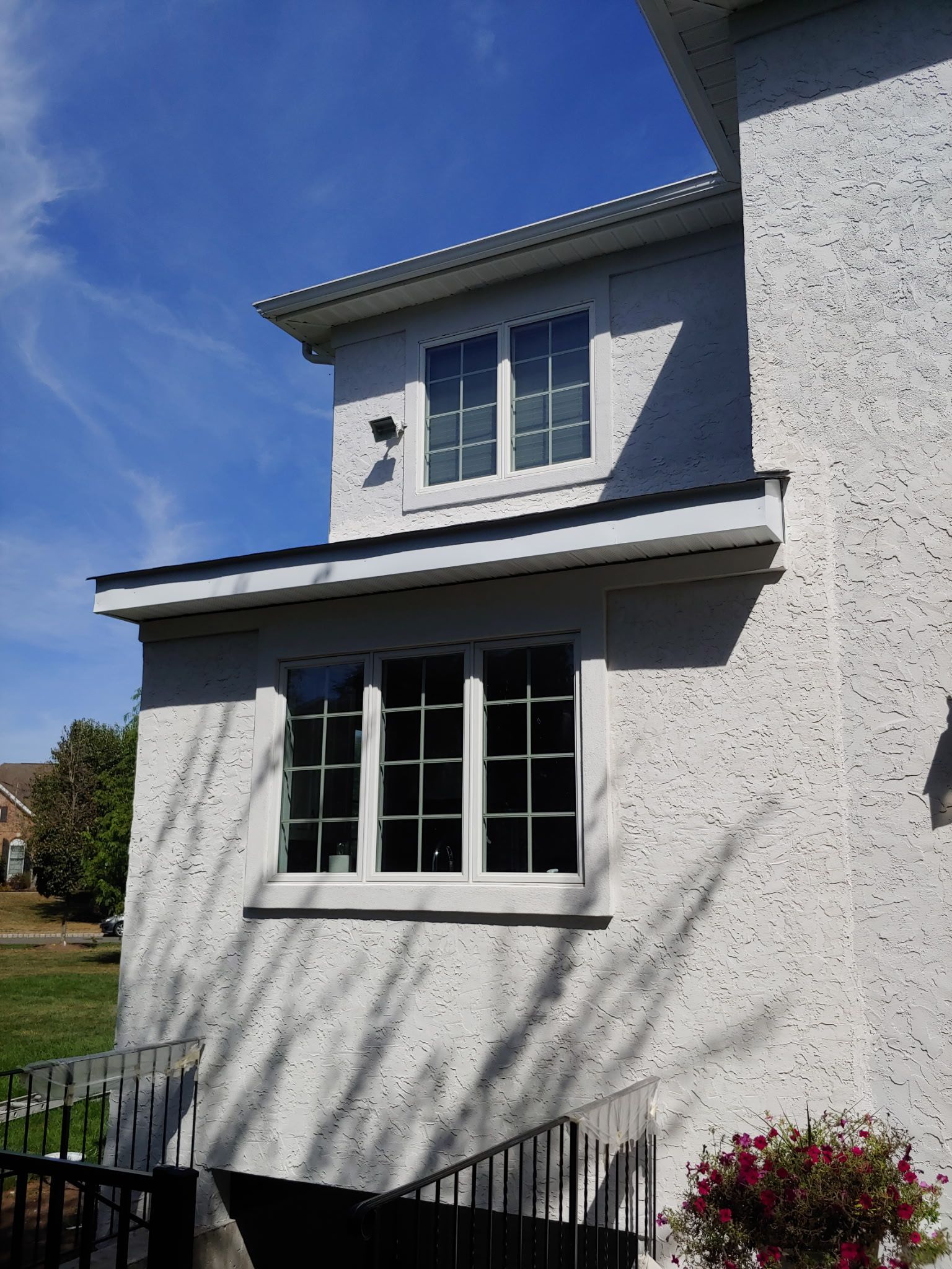 A white house with a window on the side of it