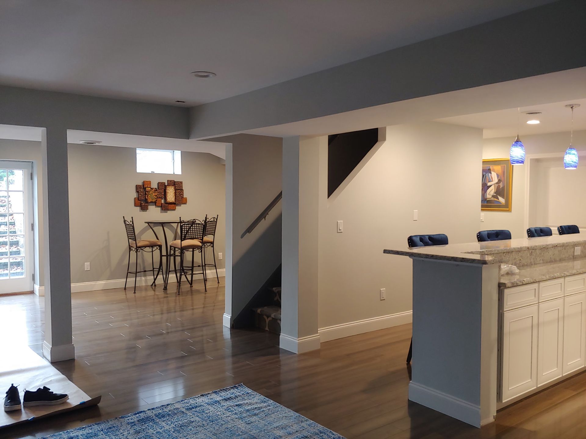 A basement with a table and chairs in it