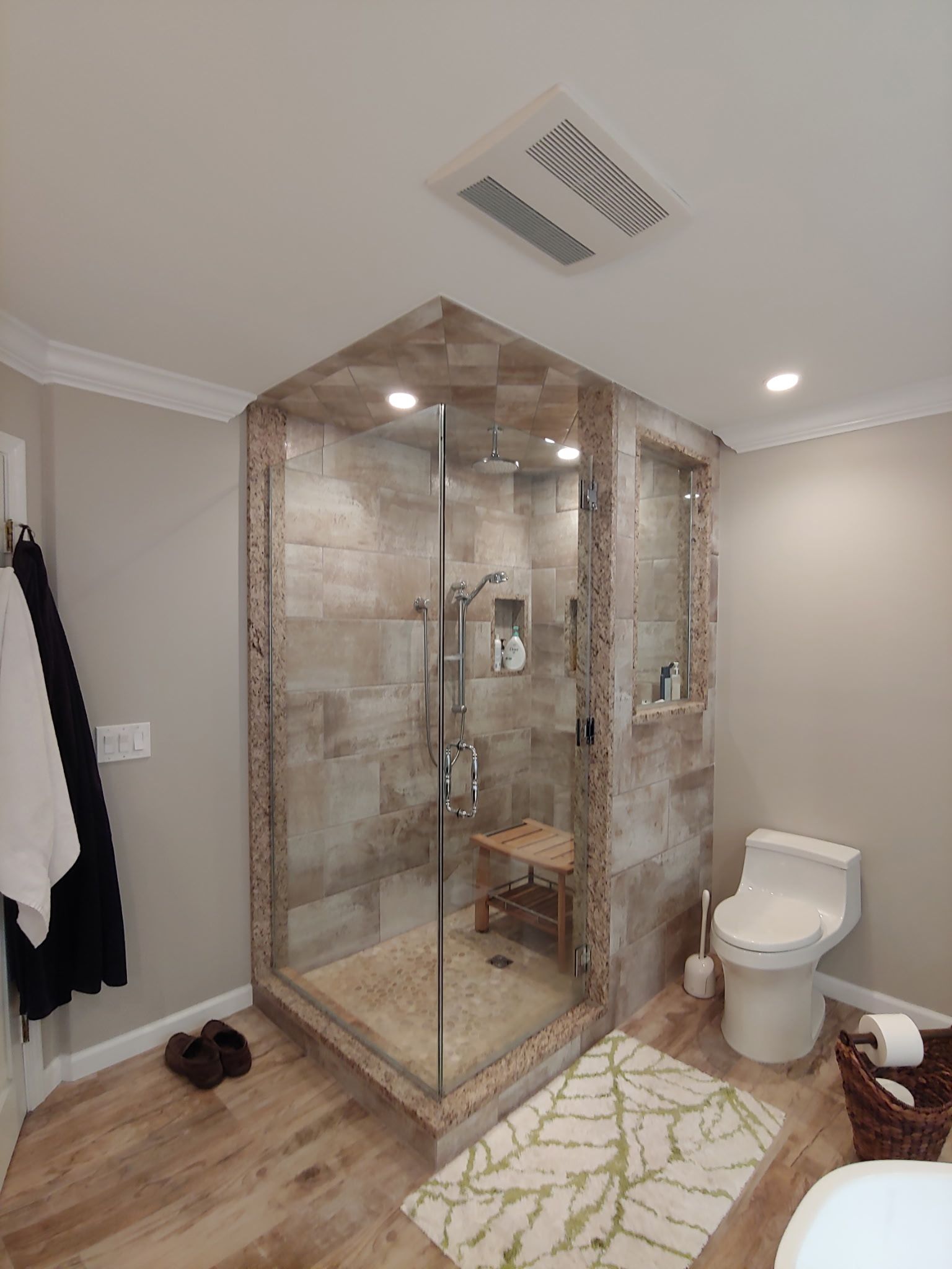 A bathroom with a walk in shower and a toilet.