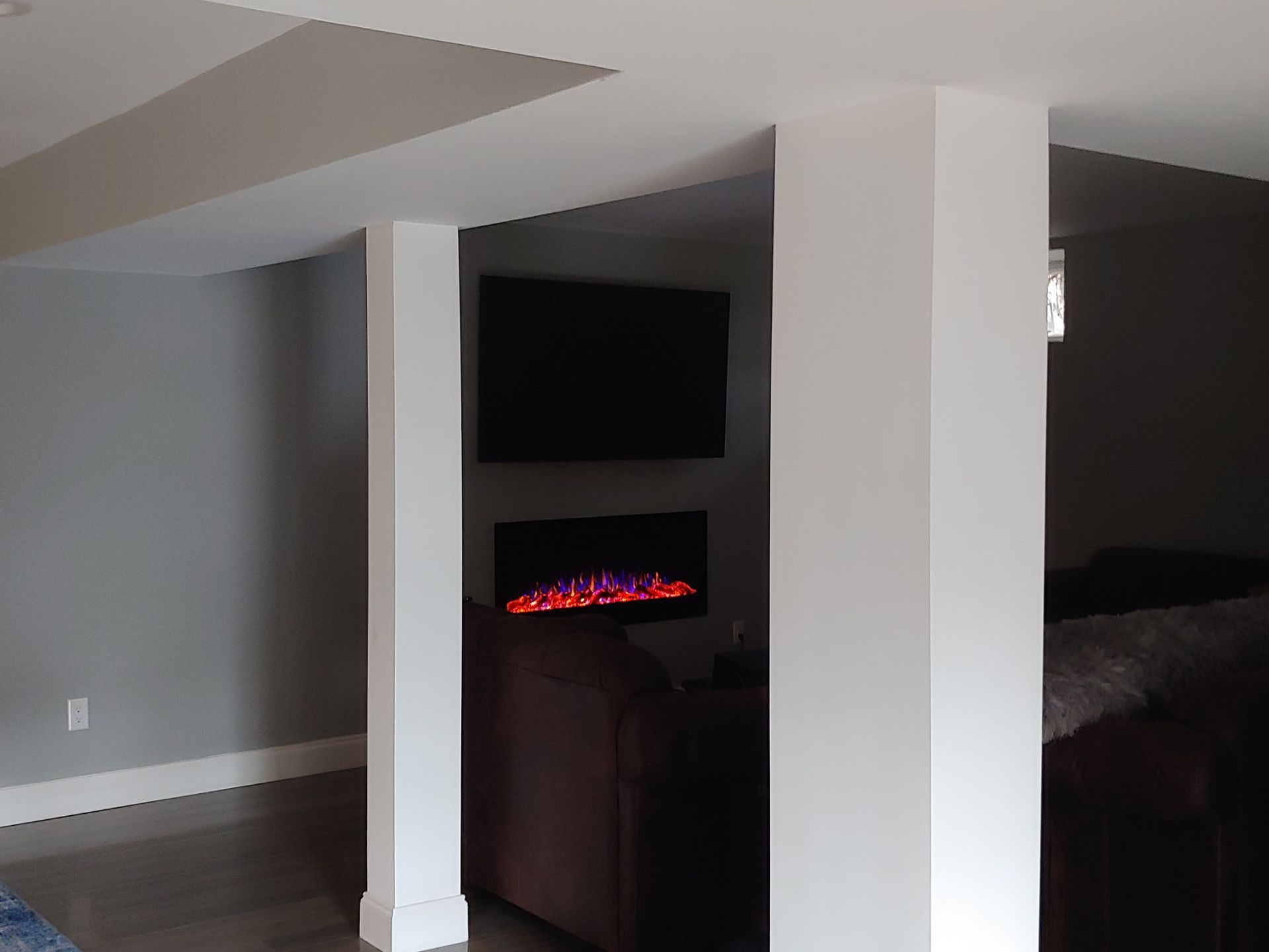 A living room with a fireplace and a flat screen tv