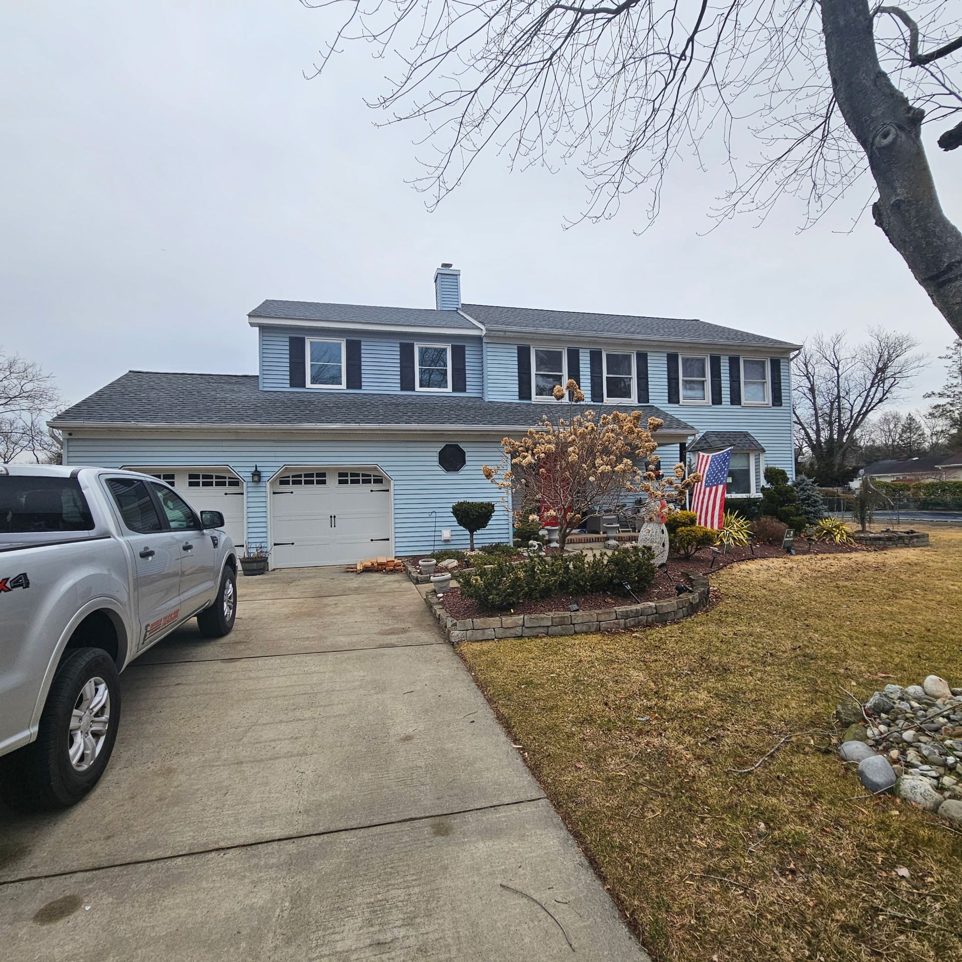 A truck is parked in front of a large house