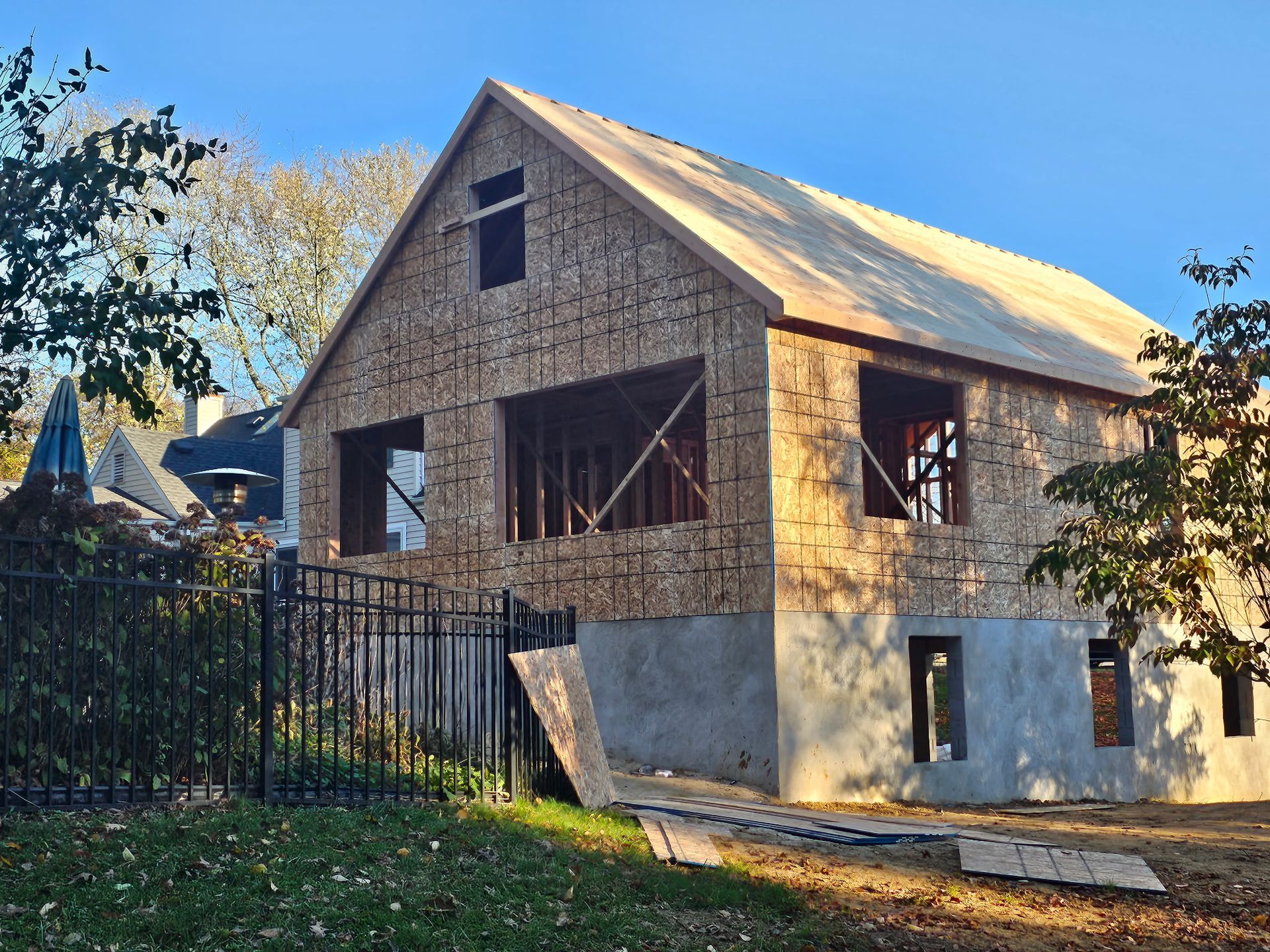 A house is being built with plywood and a wooden roof.