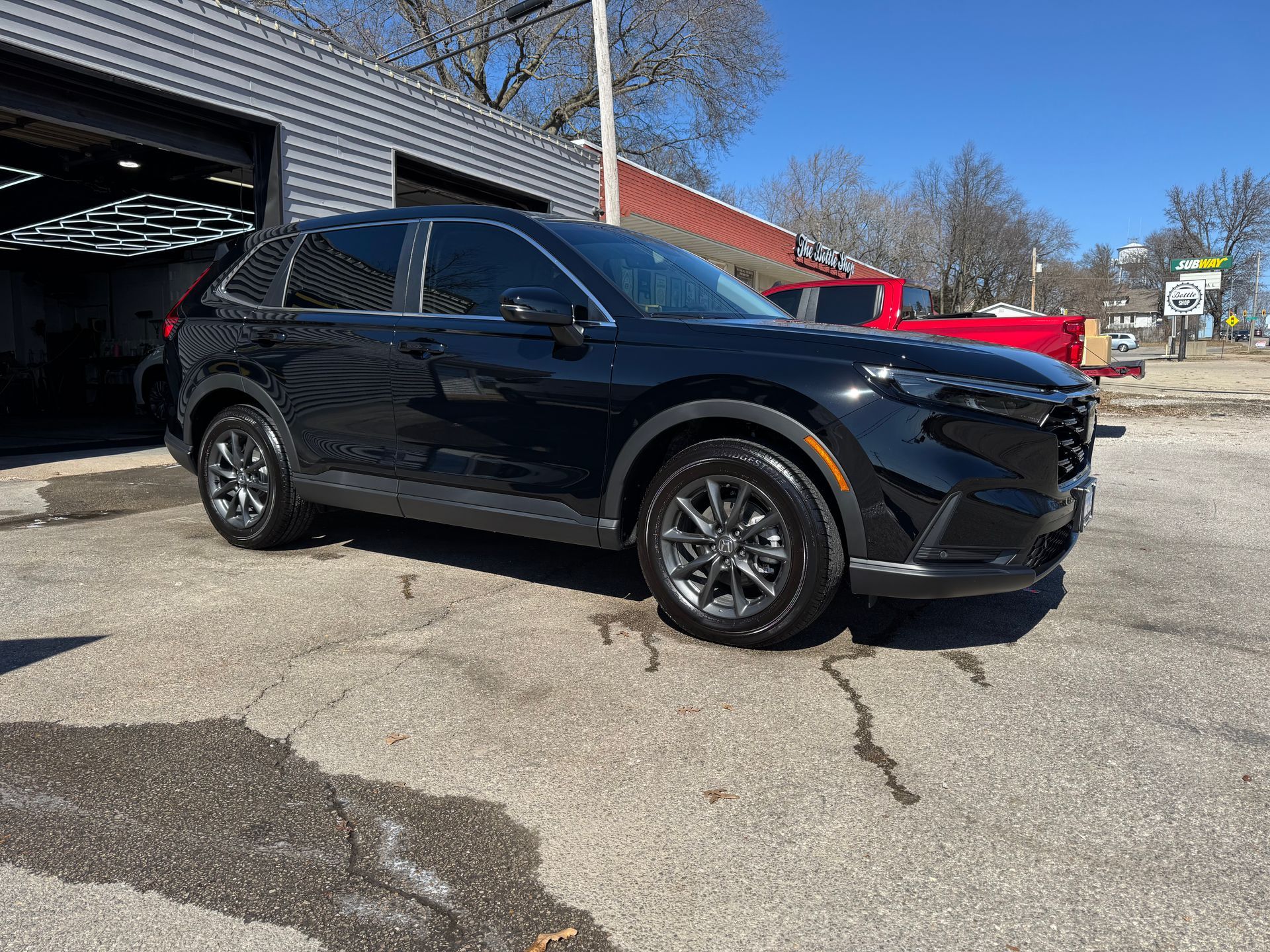 Black SUV parked outside a building on a sunny day