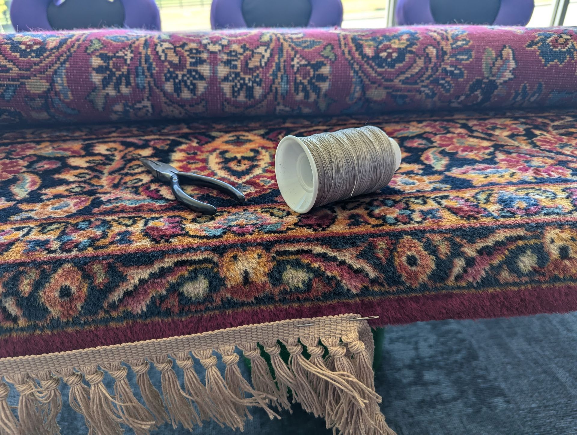 A cup is laying on top of a rug on a table.