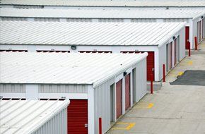 White storage buildings with flat metal roofs
