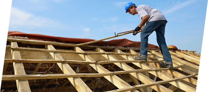 Laborer repairing a roof