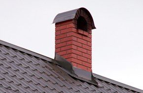 Metal roof with brick chimney