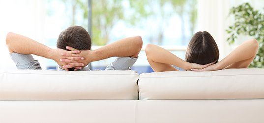 Relaxed couple sitting on a couch