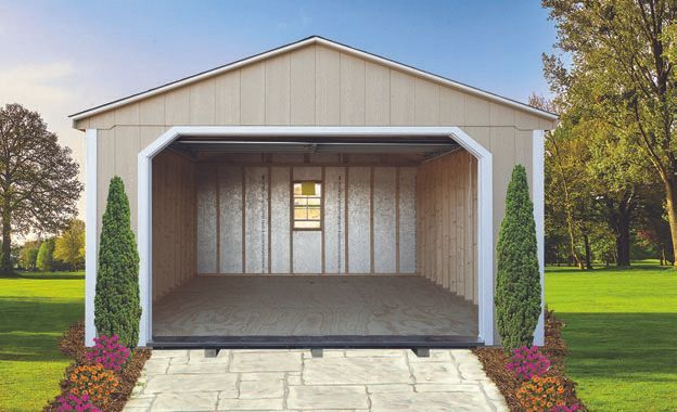 Tan shed with open garage door on a grassy lawn.