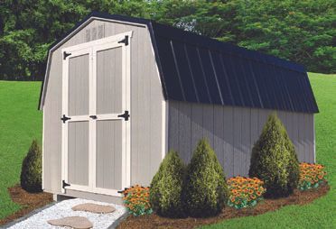 Tan barn-style shed with black roof and white-trimmed doors, set in a yard with landscaping.