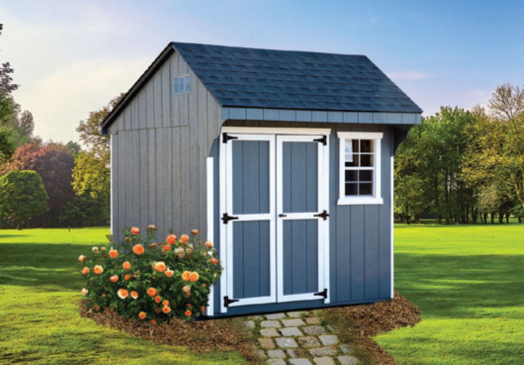 Blue shed with double doors and window, surrounded by green grass, and a paved pathway.