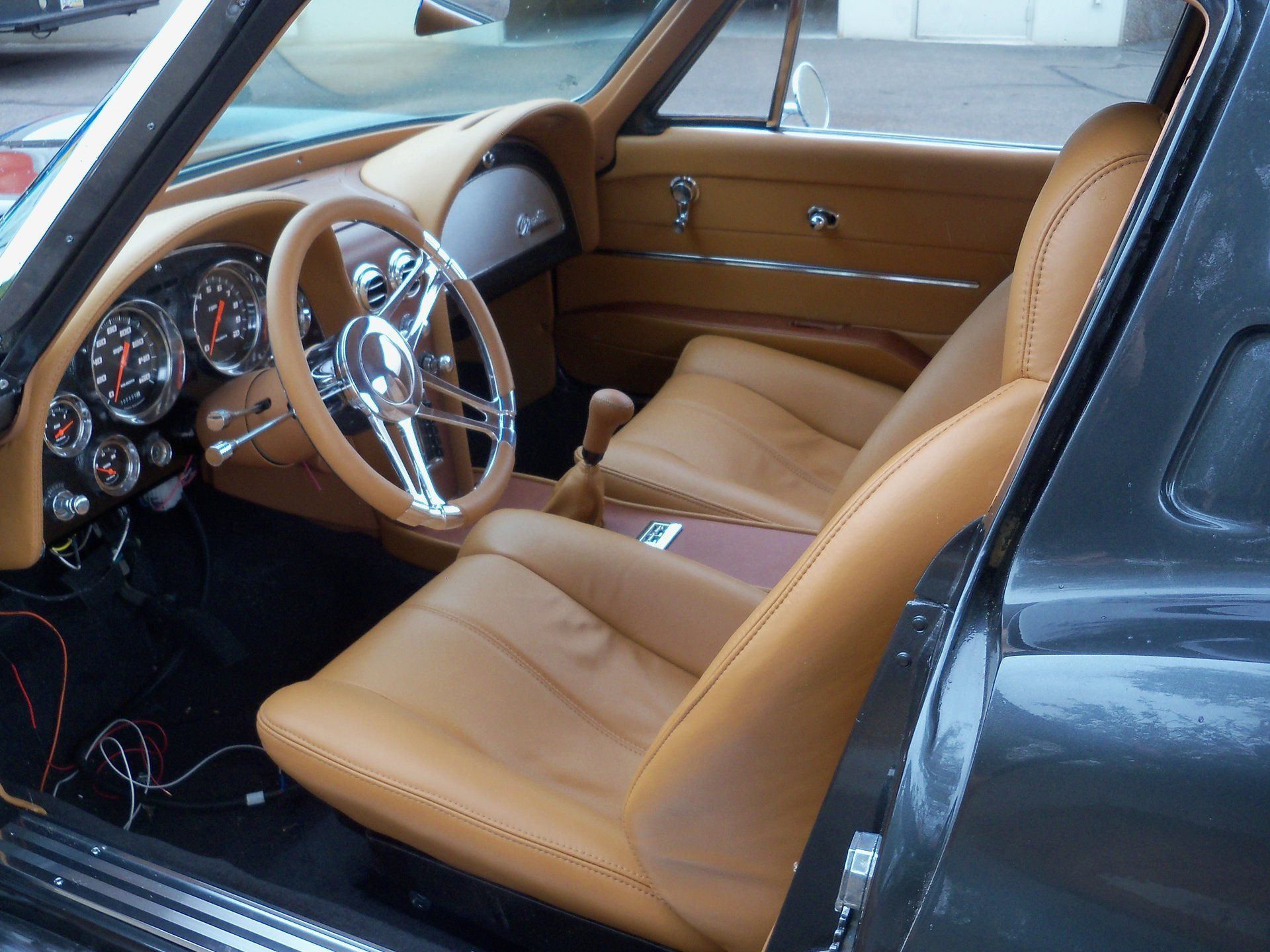 The interior of a truck with brown leather seats and a black steering wheel.