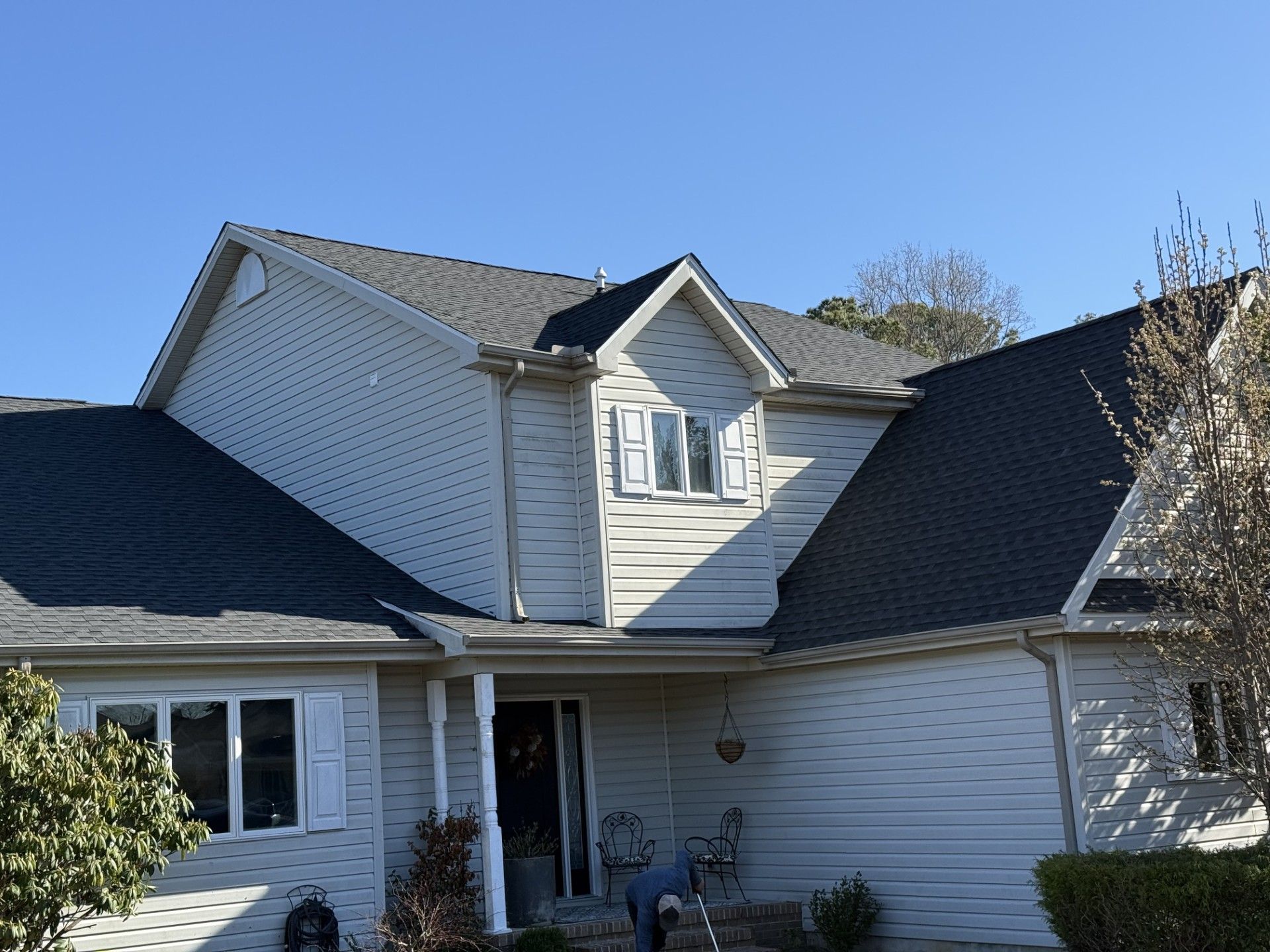 A large white house with a black roof.