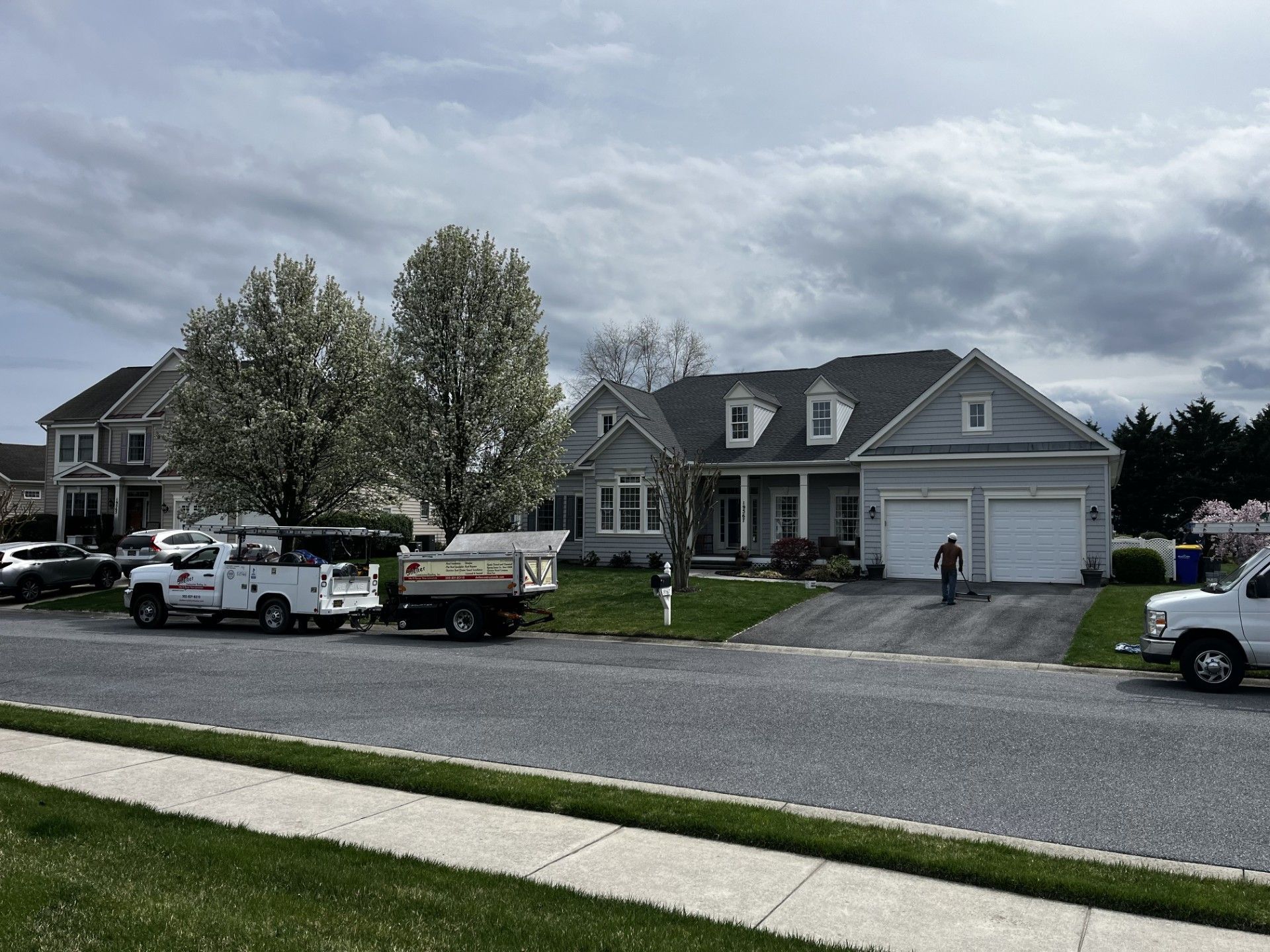 A white truck is parked in front of a house.