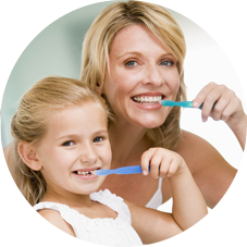 Mother and daugther brushing their teeth