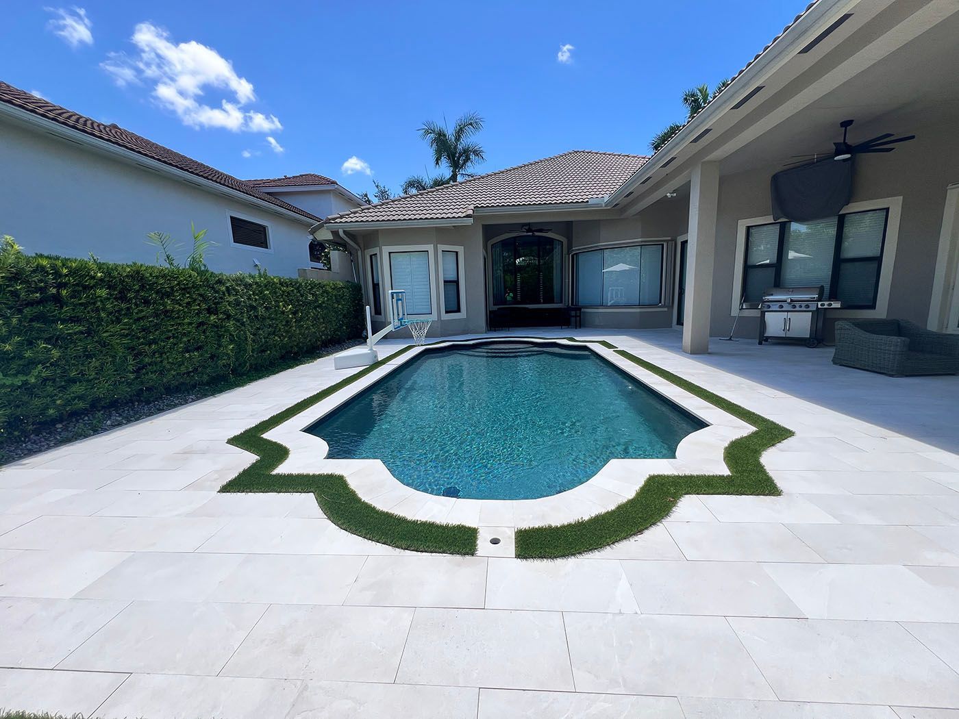 A large swimming pool with newly updated pavers