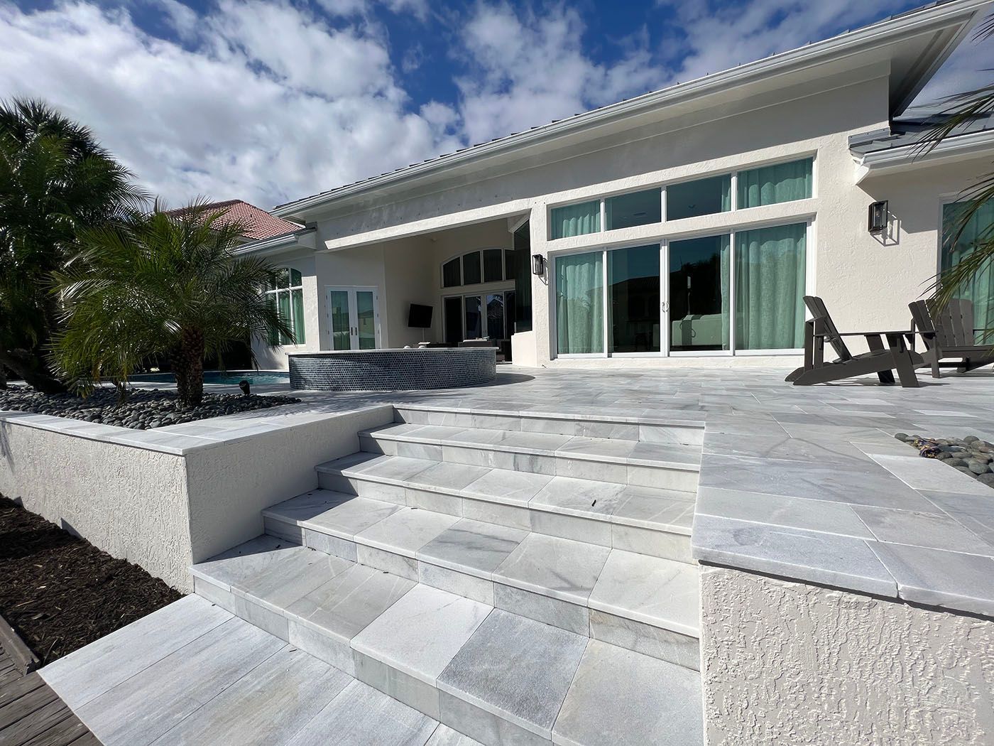 A beautiful white house with stairs leading up to it