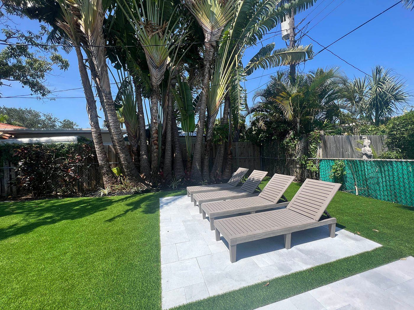 A row of lounge chairs sitting on top of a new pavers