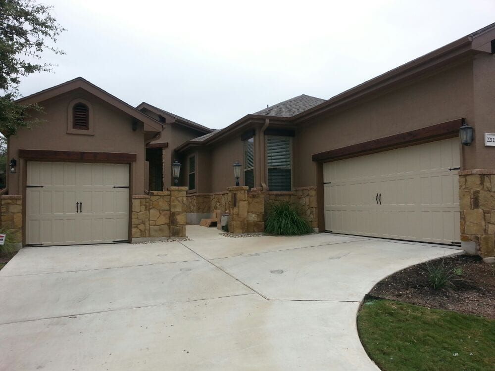 A house with two garage doors and a driveway