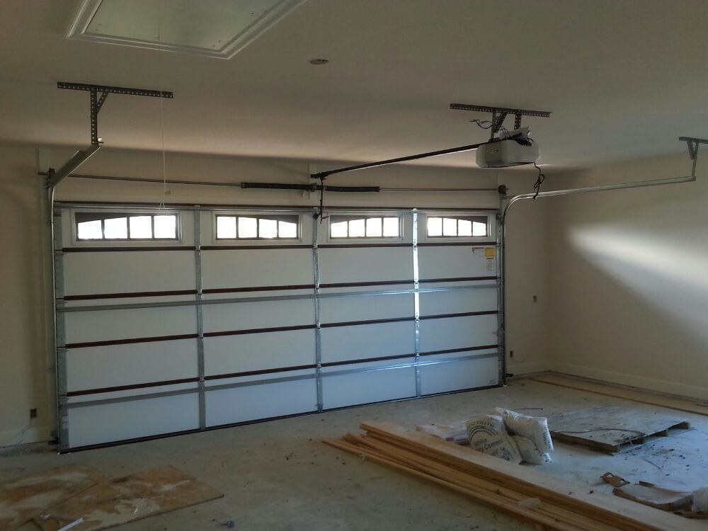 An empty garage with a garage door open