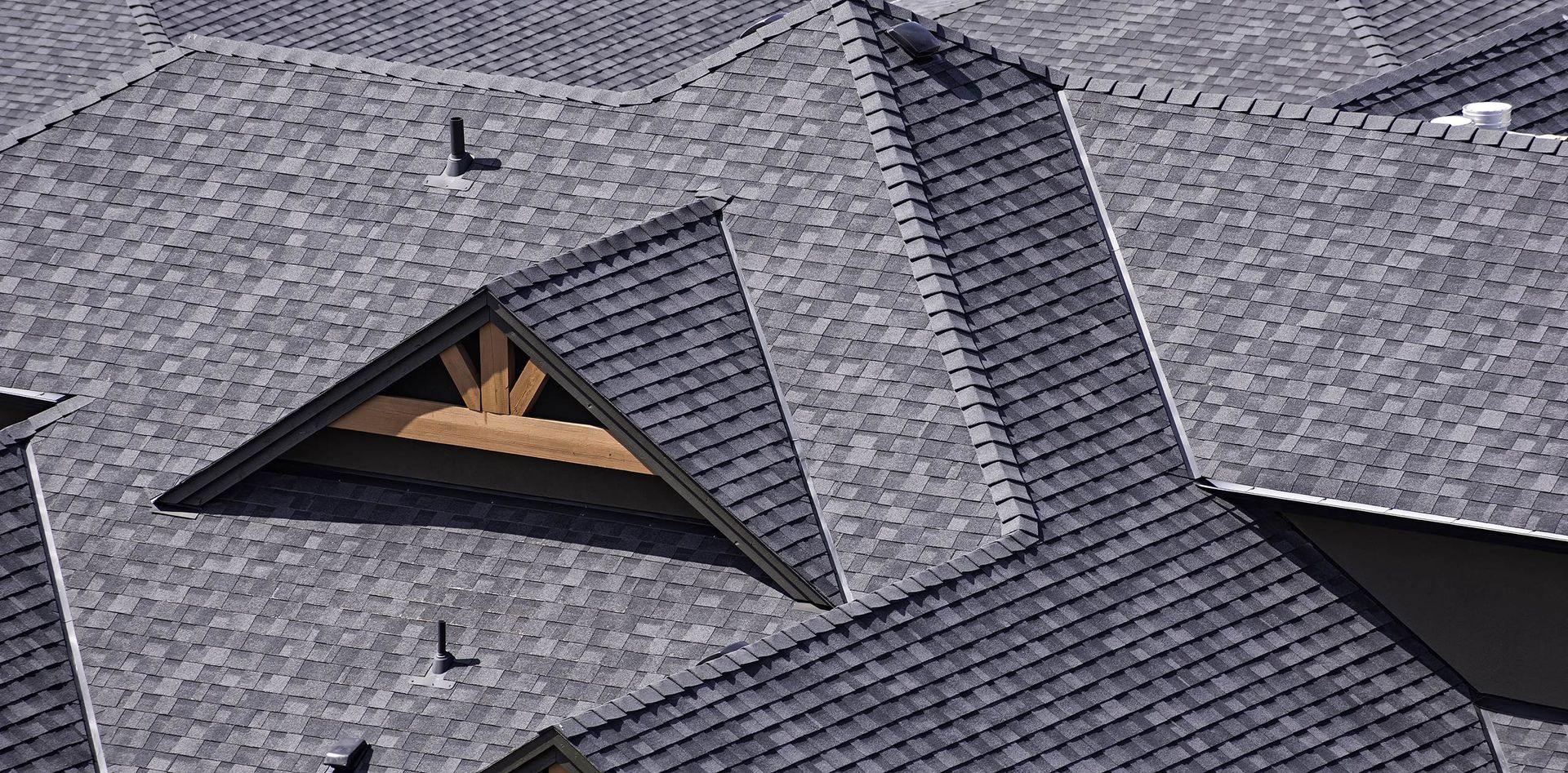 An aerial view of a house with a gray roof and a window.