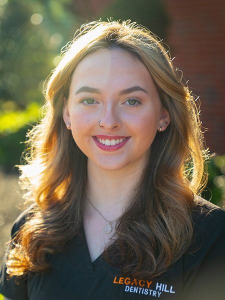 Woman smiling, wearing black shirt with 