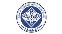 The logo for the korean american dental association has a caduceus on it.