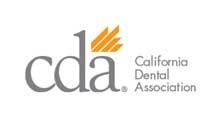 The logo for the california dental association is gray and orange.