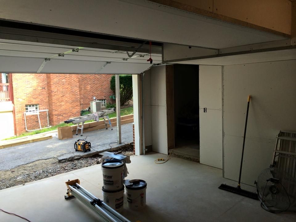 A garage with a sliding garage door is being remodeled