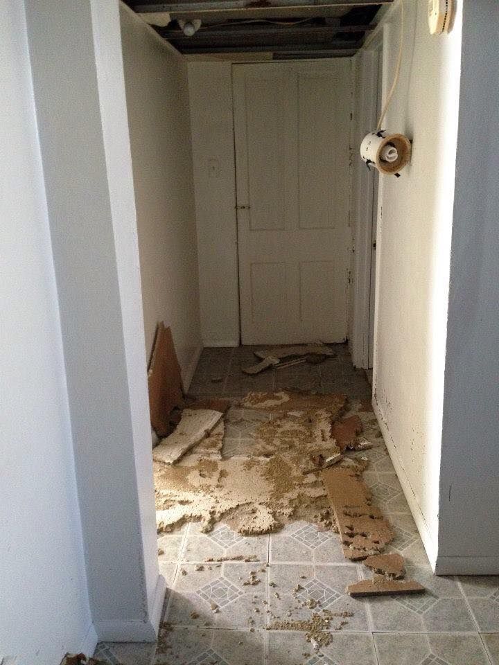 A hallway with a lot of cardboard on the floor.