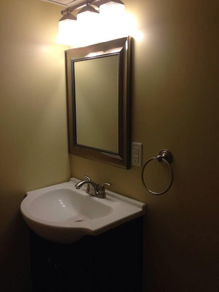 A bathroom sink with a mirror above it
