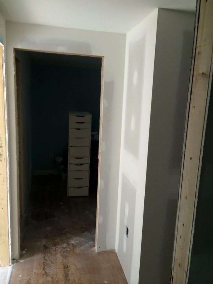 A hallway with a stack of drawers in the corner