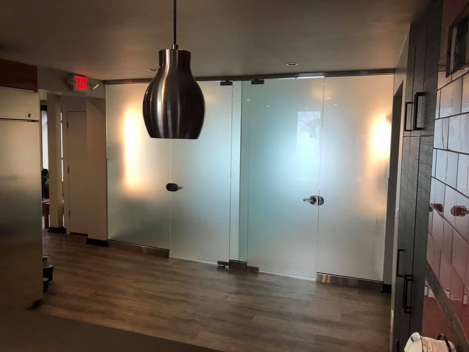 A hallway with sliding glass doors and a pendant light.