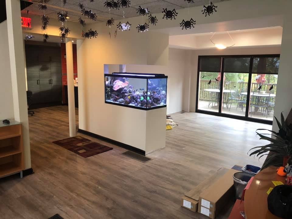 There is a large aquarium in the middle of the room.