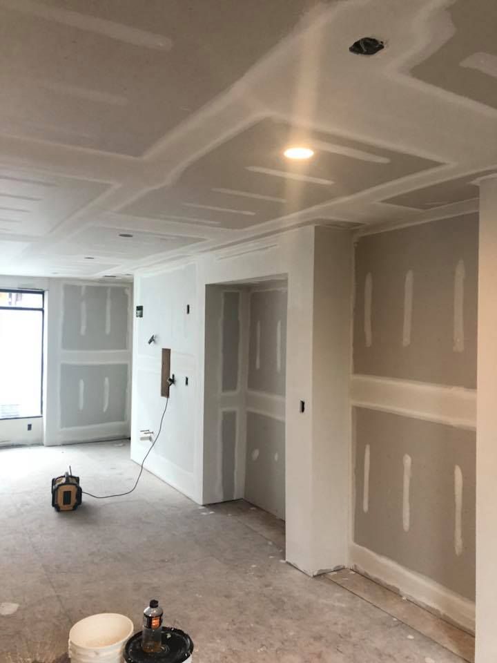 A room that is being remodeled with drywall on the walls.