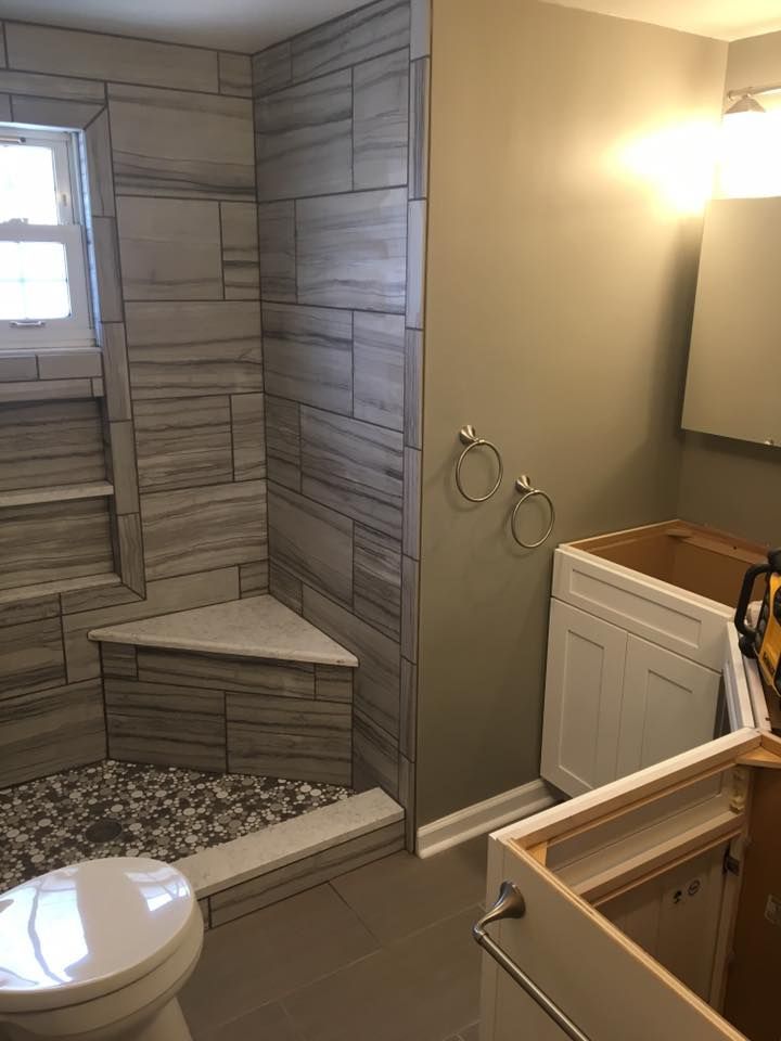 A bathroom with a toilet , sink , and shower.